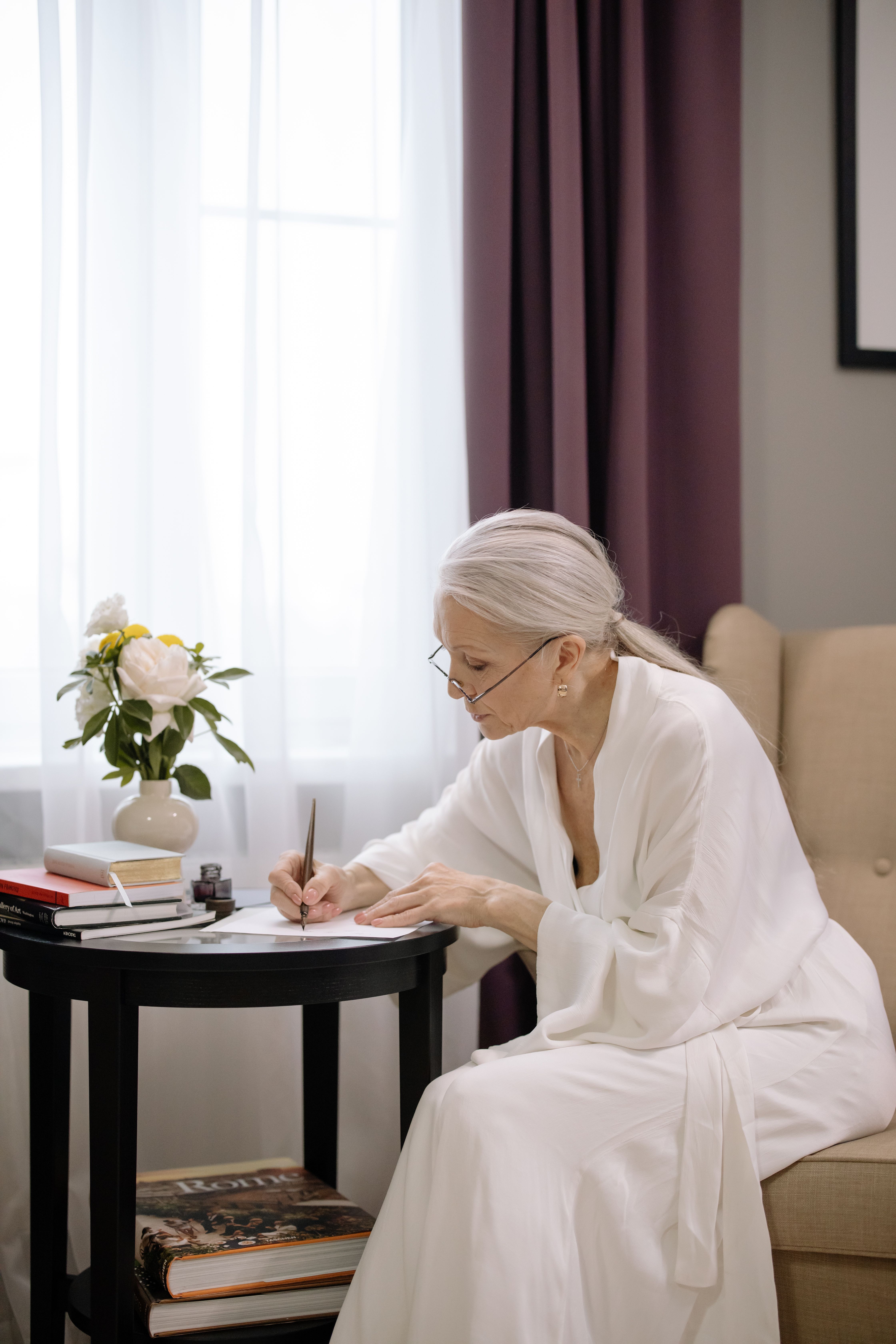 Elderly Woman in White Robe Writing with a Fountain Pen · Free Stock Photo