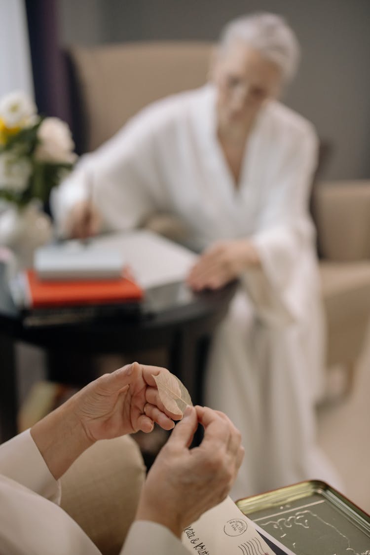 Person Holding A White Leaf