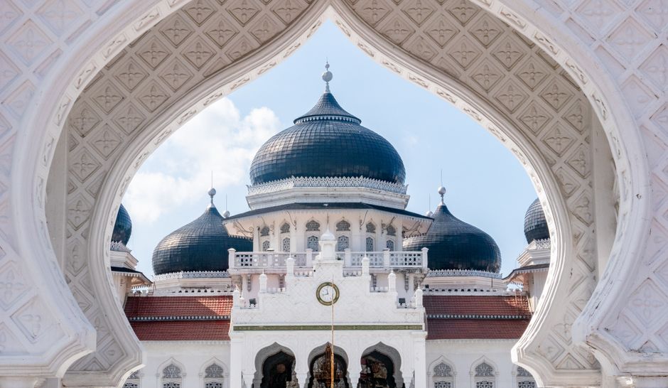 Stunning view of Baiturrahman Grand Mosque in Banda Aceh, showcasing its elegant domes and intricate details.