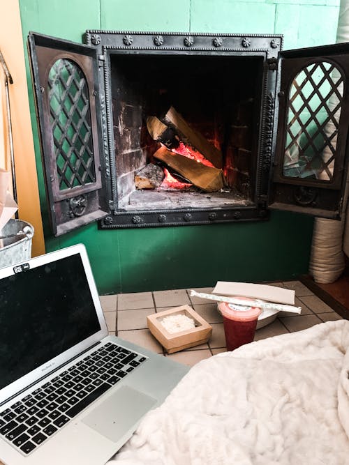 Free Laptop near fireplace in room Stock Photo