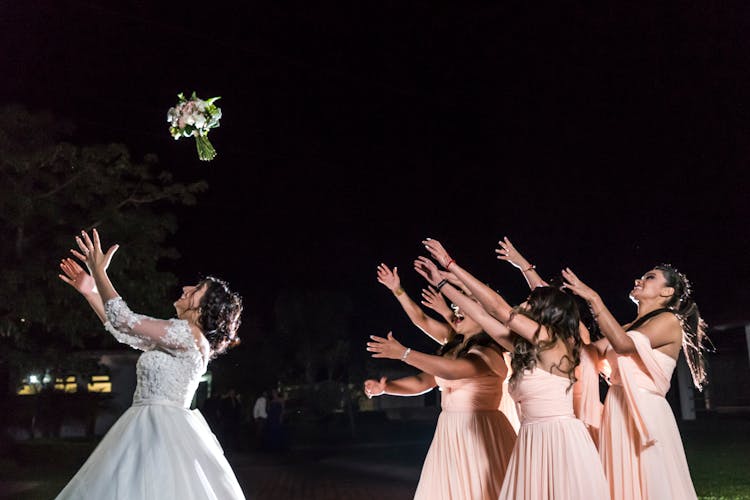 Bride Throwing A Bouquet Of Flowers