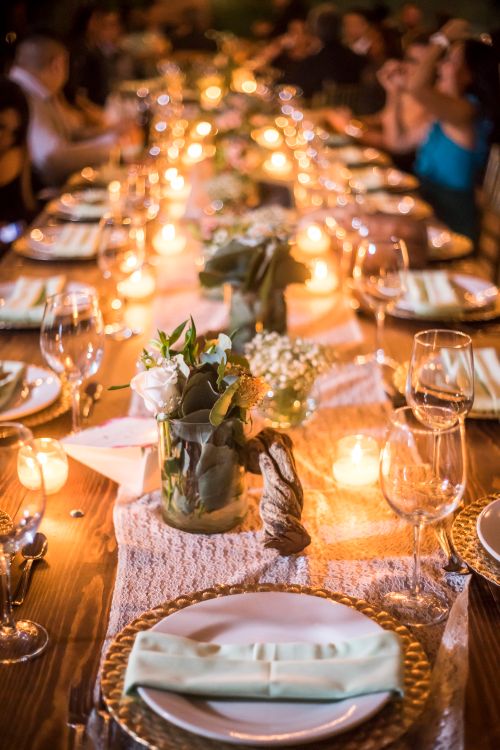 Free Warm and inviting candlelit dinner table with floral decorations perfect for a celebration. Stock Photo