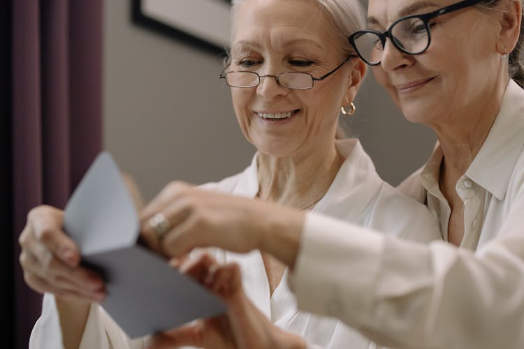 Two Elderly Women Looking An Envelope