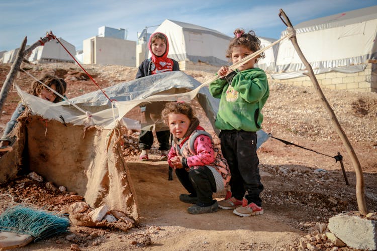 Cute Ethnic Poor Children Playing In Shabby Yard