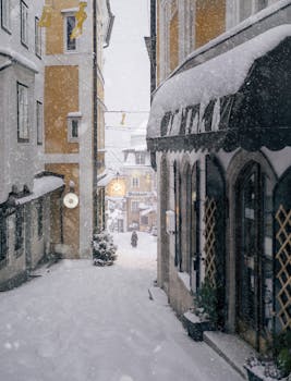 A scenic winter street in Gmunden, Austria covered in snow with historic buildings around.