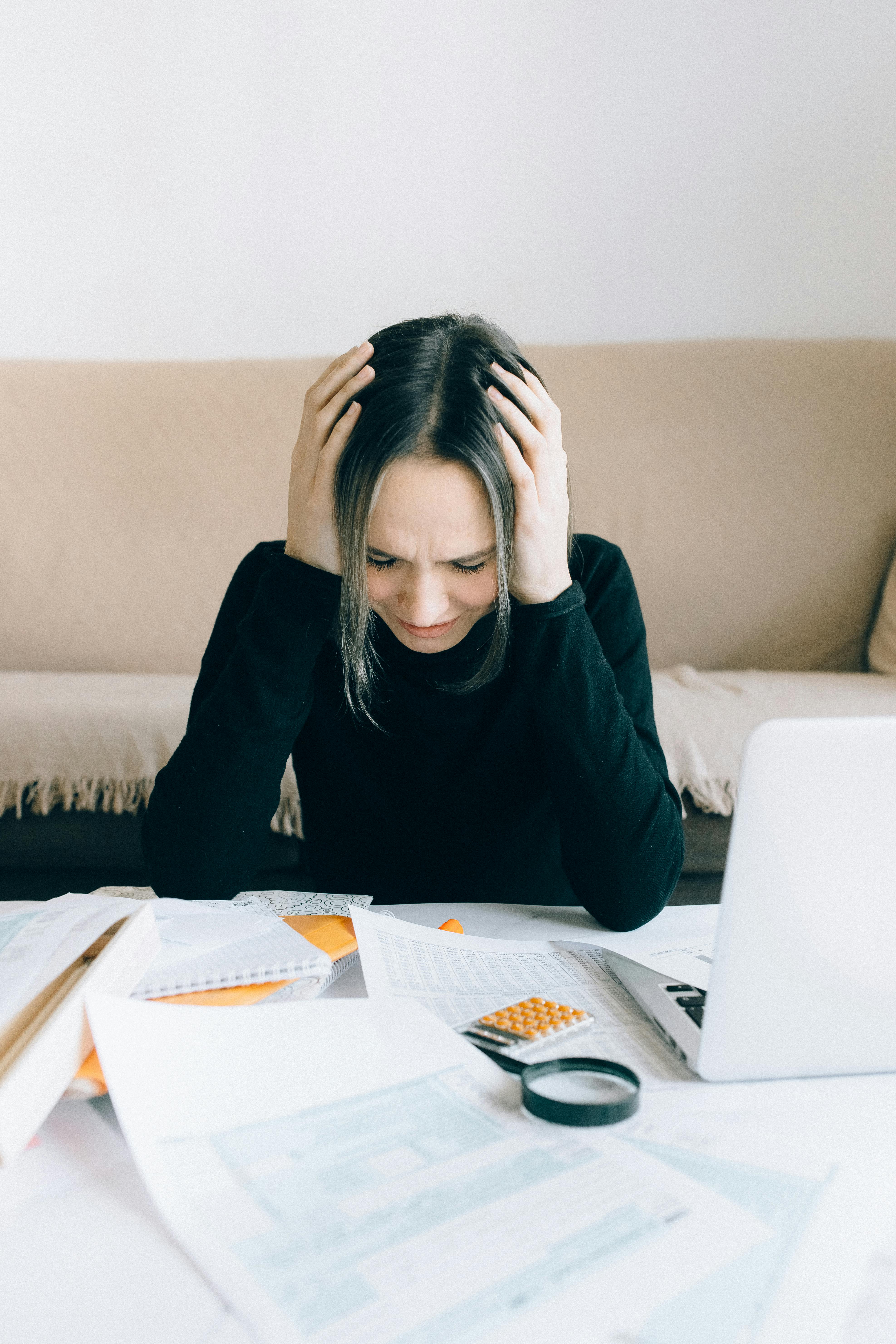 exhausted woman holding her head