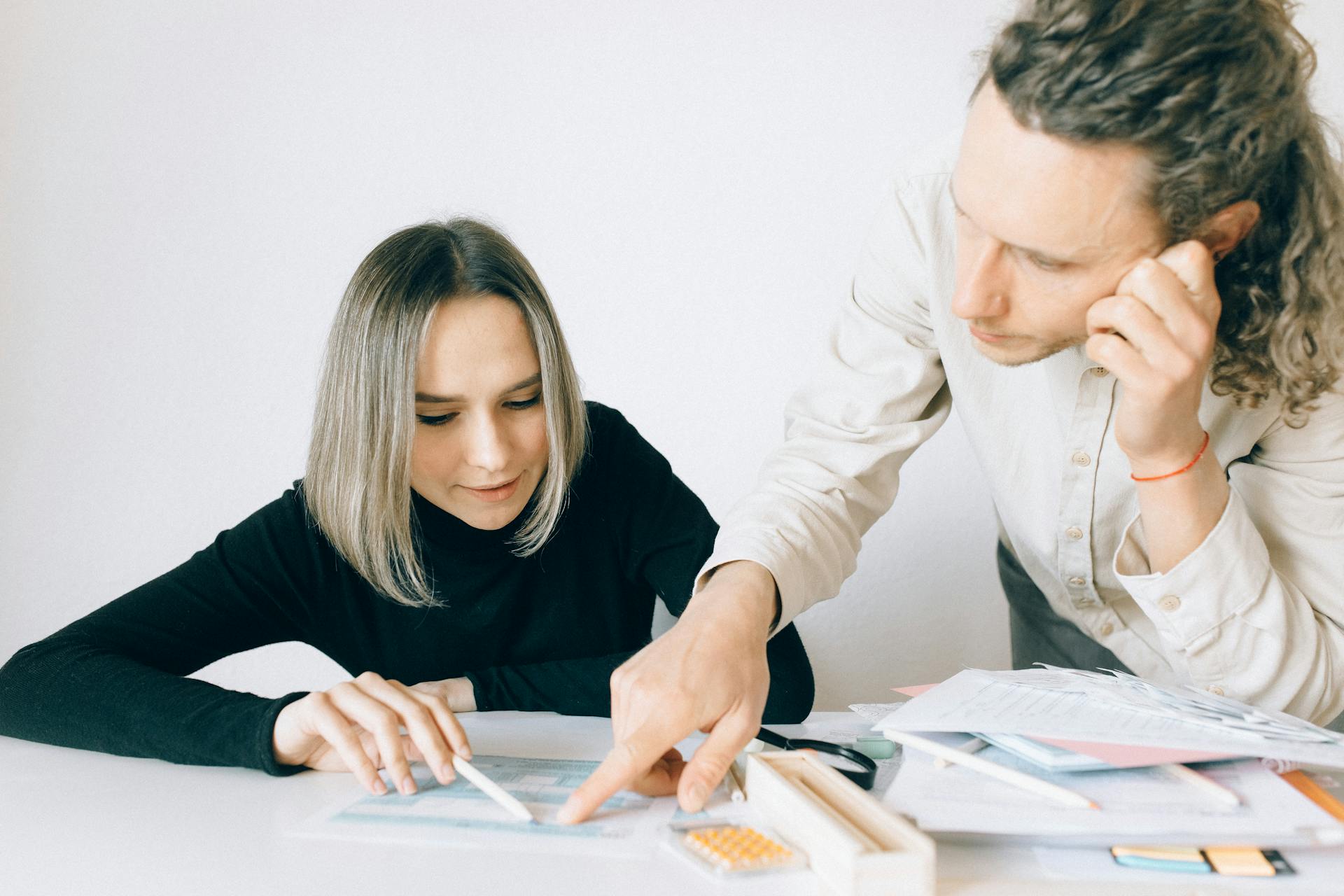 Man and Woman Looking at the Document