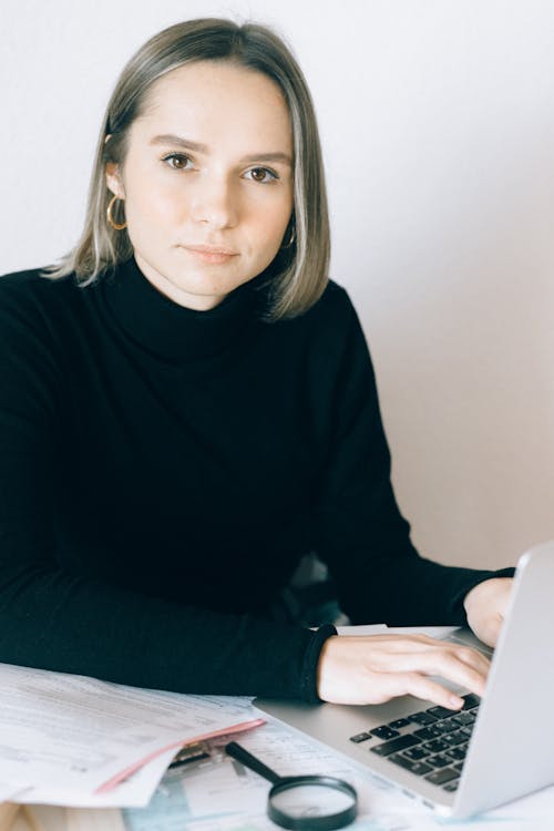 Woman in Black Long Sleeve Shirt Using Laptop