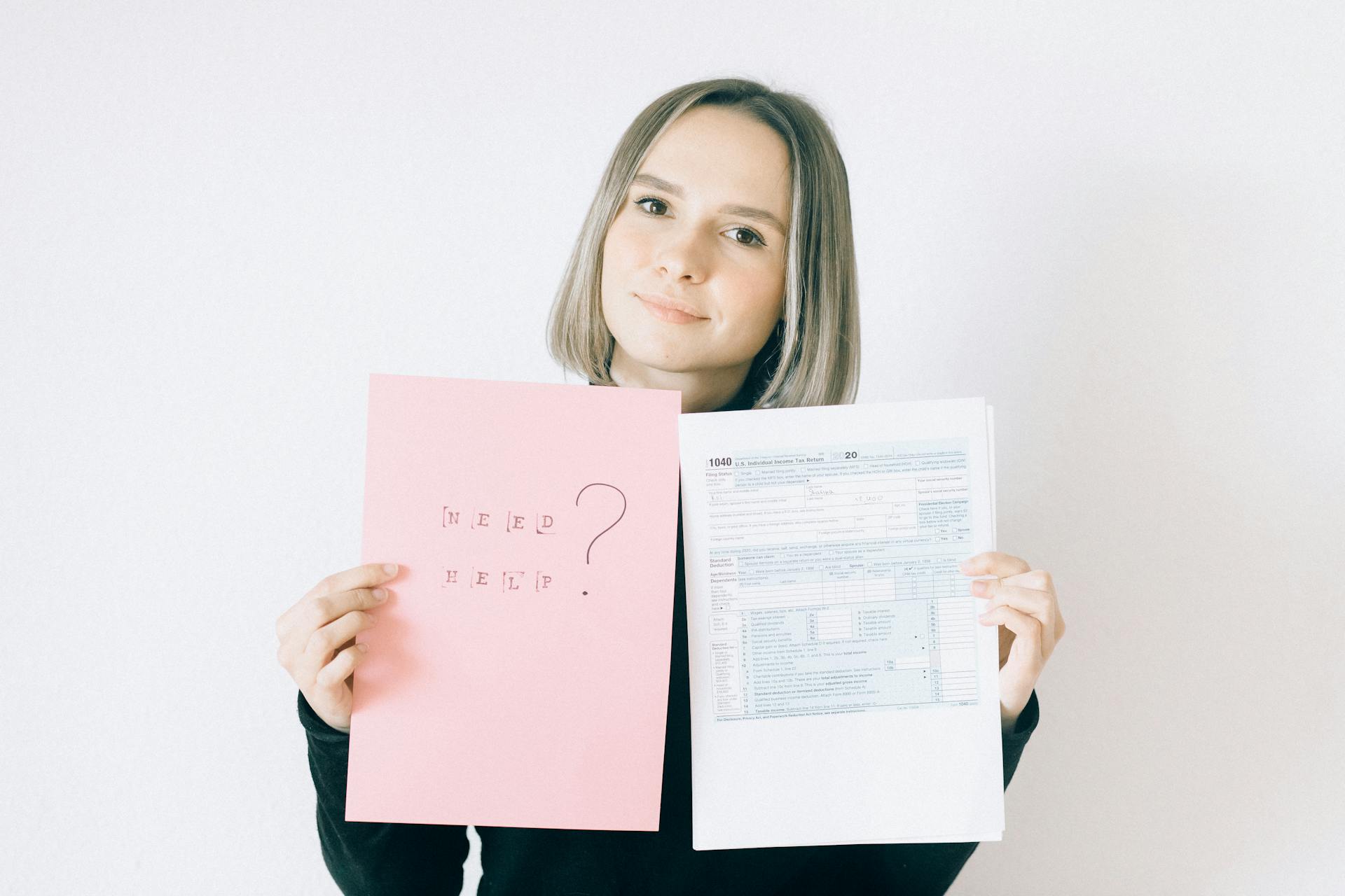 Woman Holding A Pink Paper Offering Service On Tax Forms