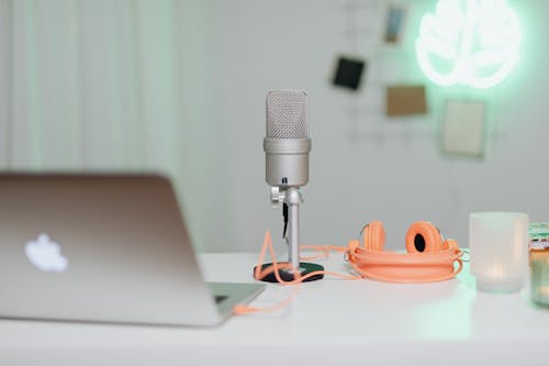 Silver Microphone and Headphone on a White Table