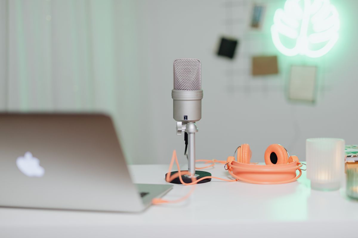 Desk with microphone, laptop and headphones