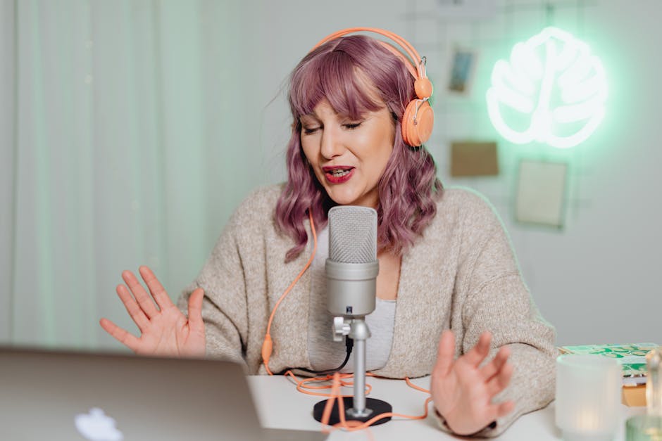 A Woman Talking on a Microphone while Wearing a Headphone