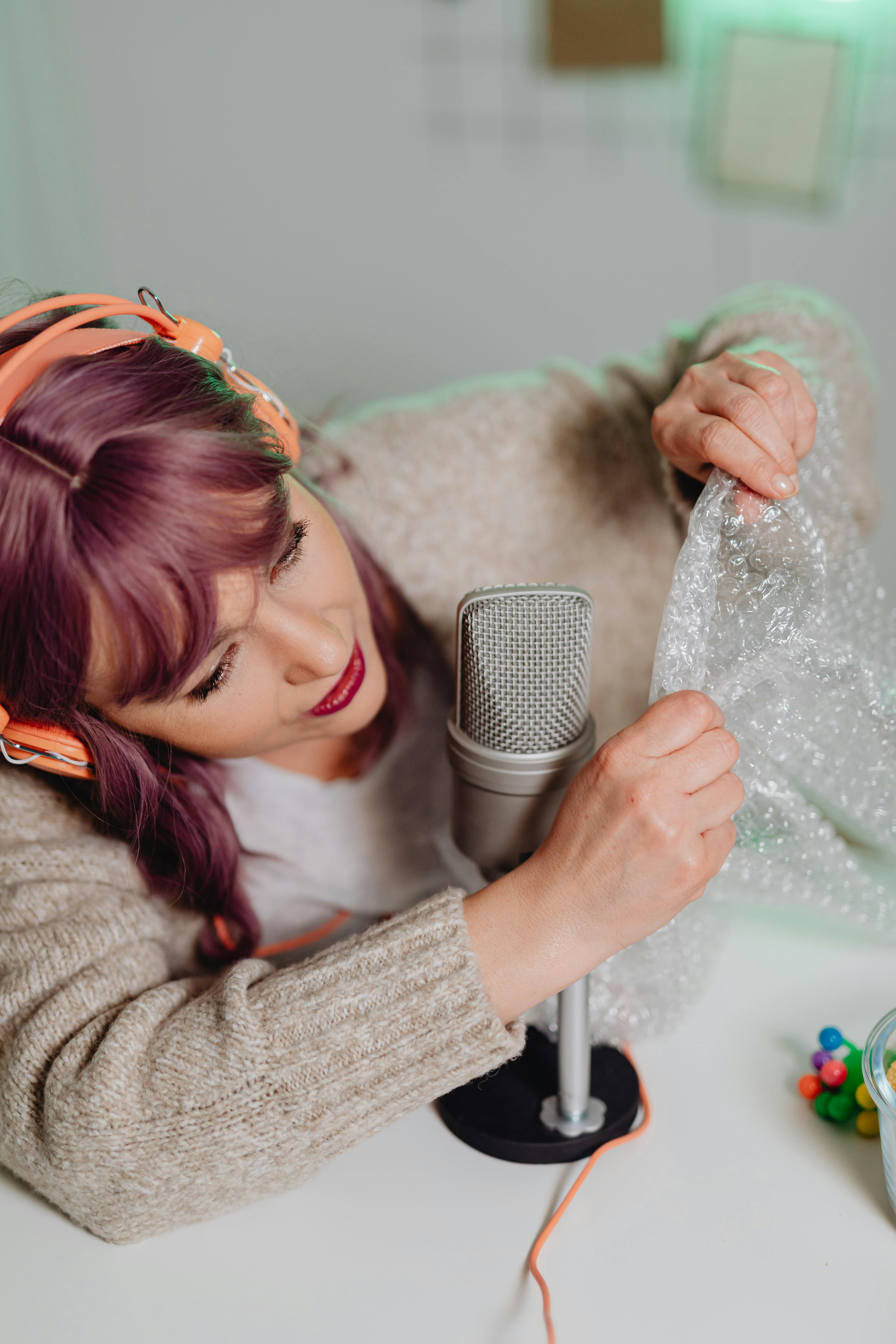 a woman in gray sweater holding a bubble wrap