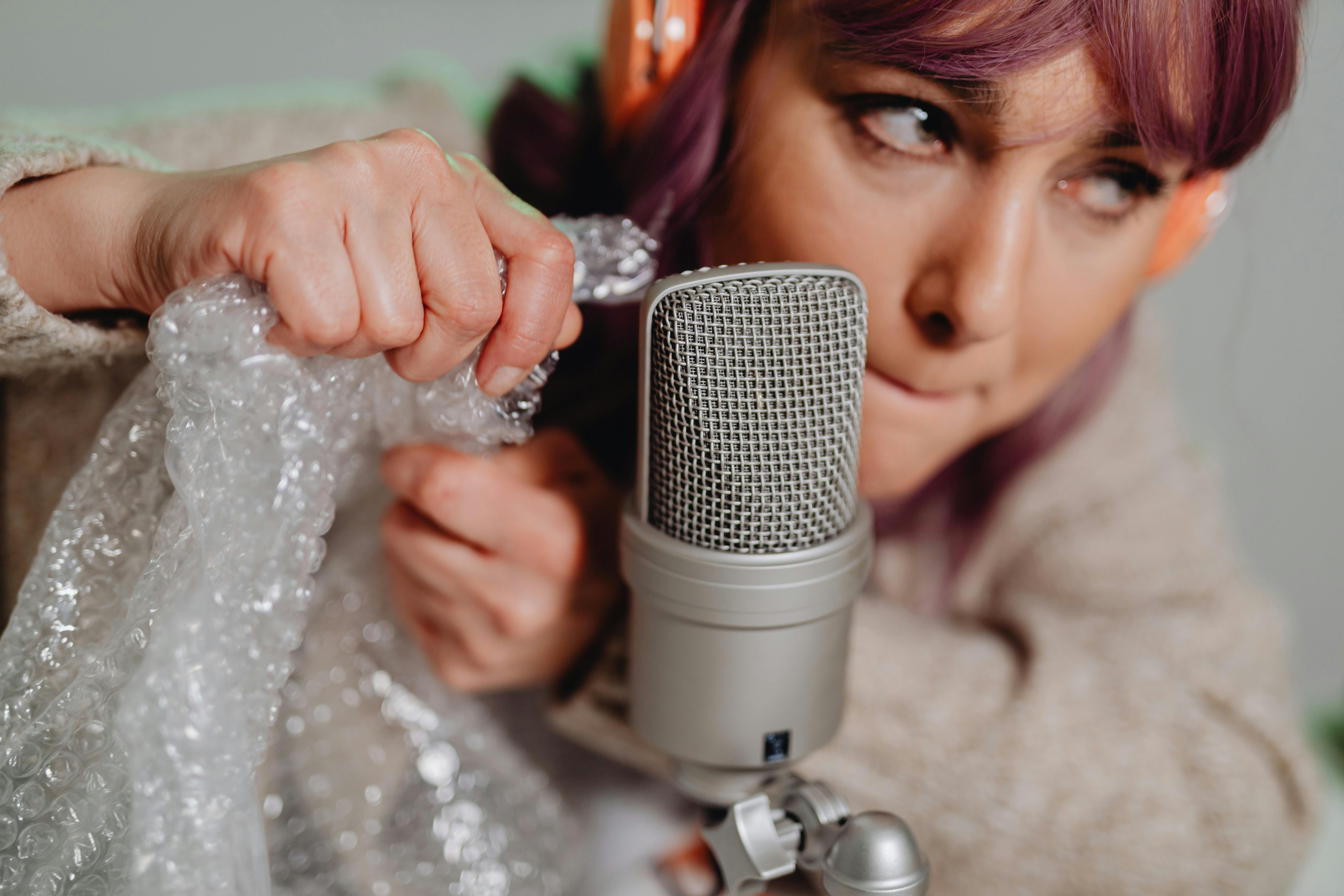 Woman Holding White and Black Portable Speaker