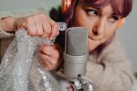 Woman Holding White and Black Portable Speaker
