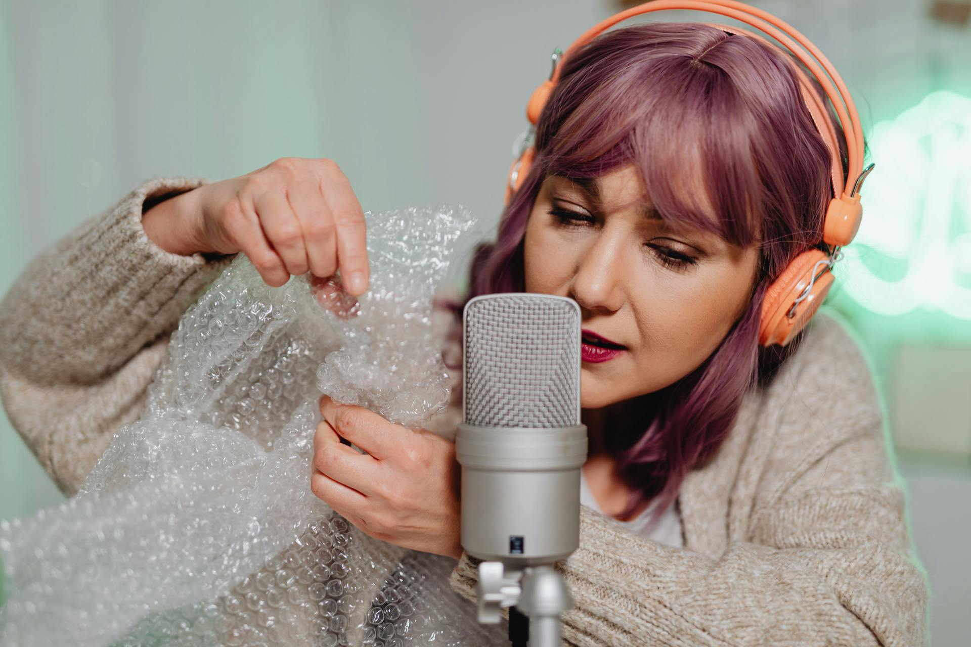 A Woman in Gray Sweater Holding a Bubble Wrap