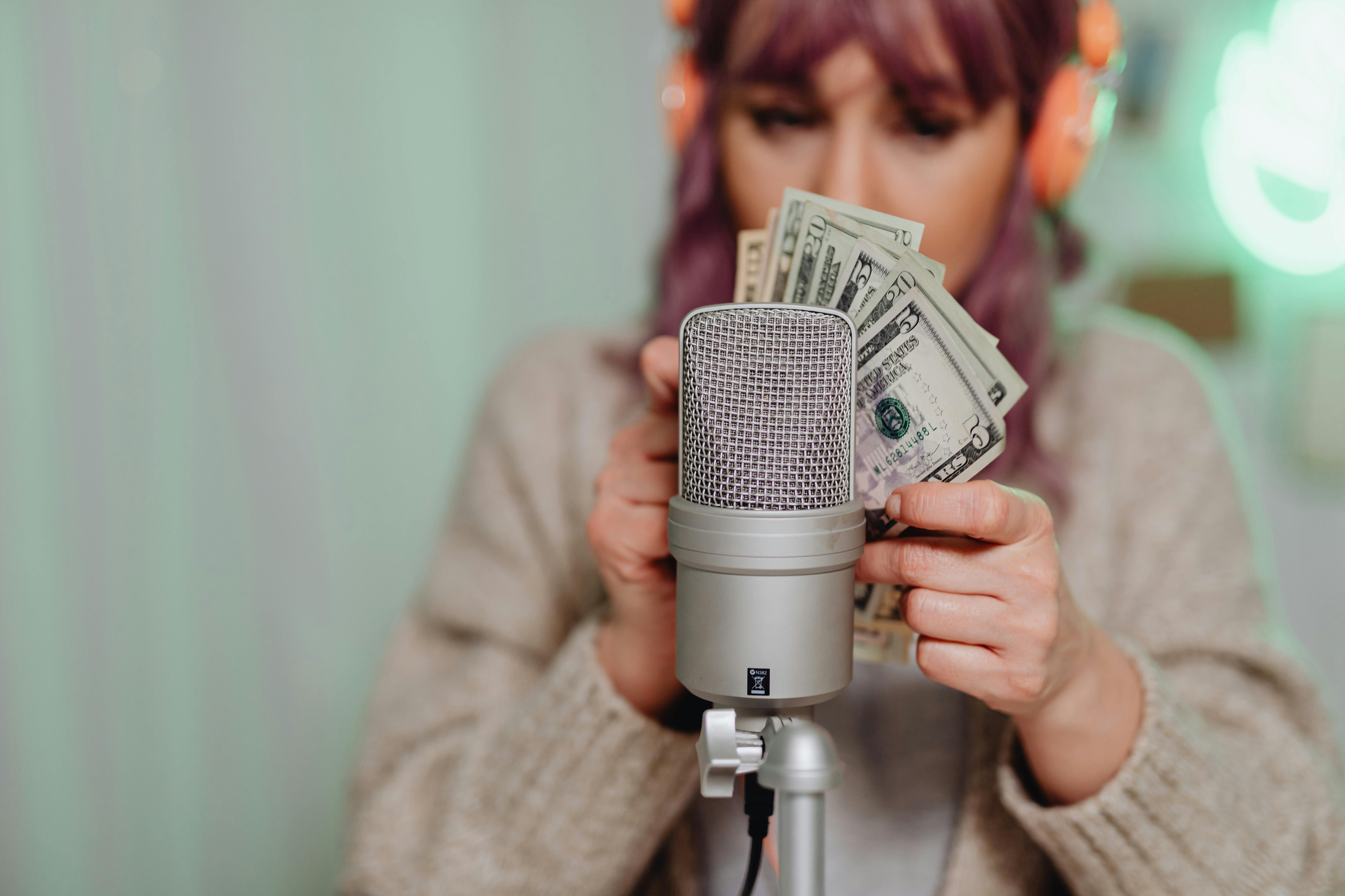 a woman holding us dollar bill