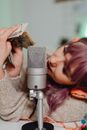 Woman in Gray Sweater Holding Microphone