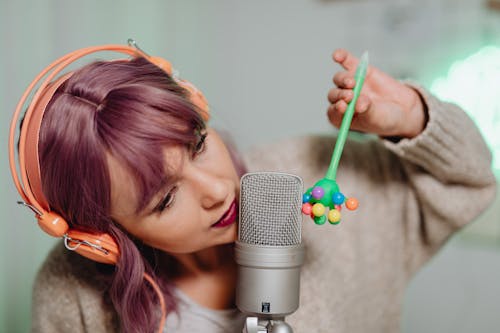 A Woman Recording on a Microphone