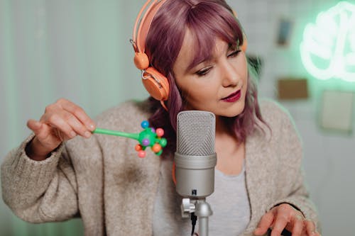 A Woman Recording on a Microphone