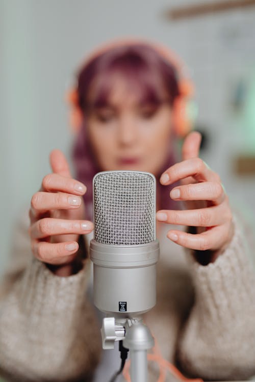 A Woman Touching a Microphone