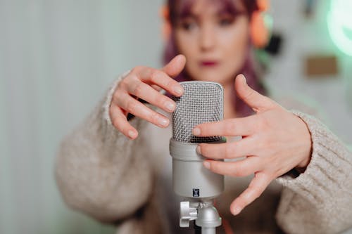 A Woman Touching a Microphone