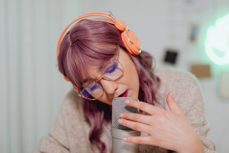 A Woman Talking On A Microphone