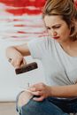 A Woman Holding a Hammer