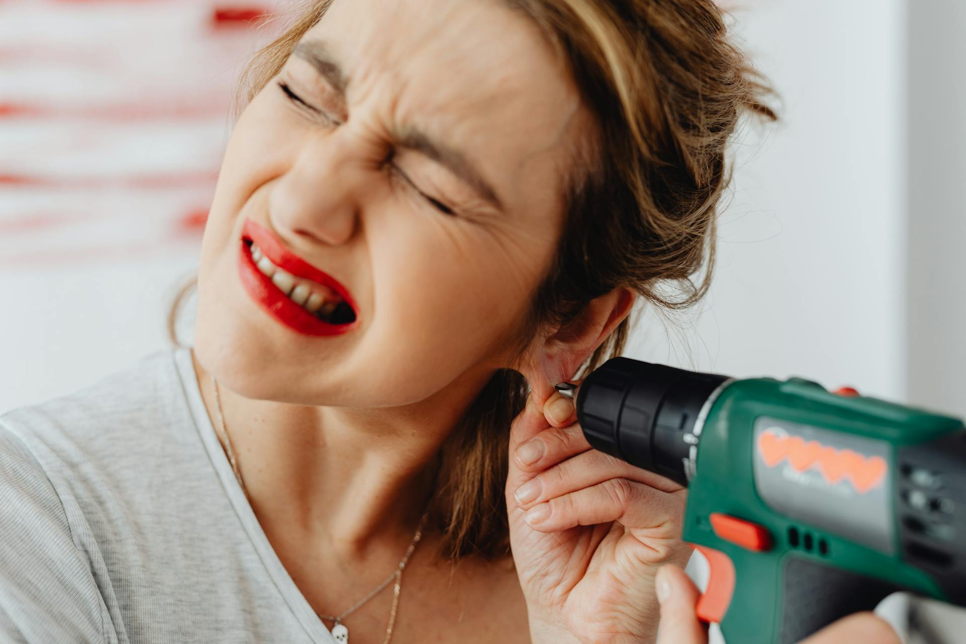 A Woman Holding Green and Black Cordless Power Drill