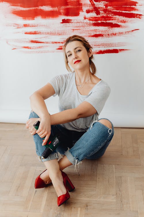 Woman with Red Shoes Sitting on the Floor