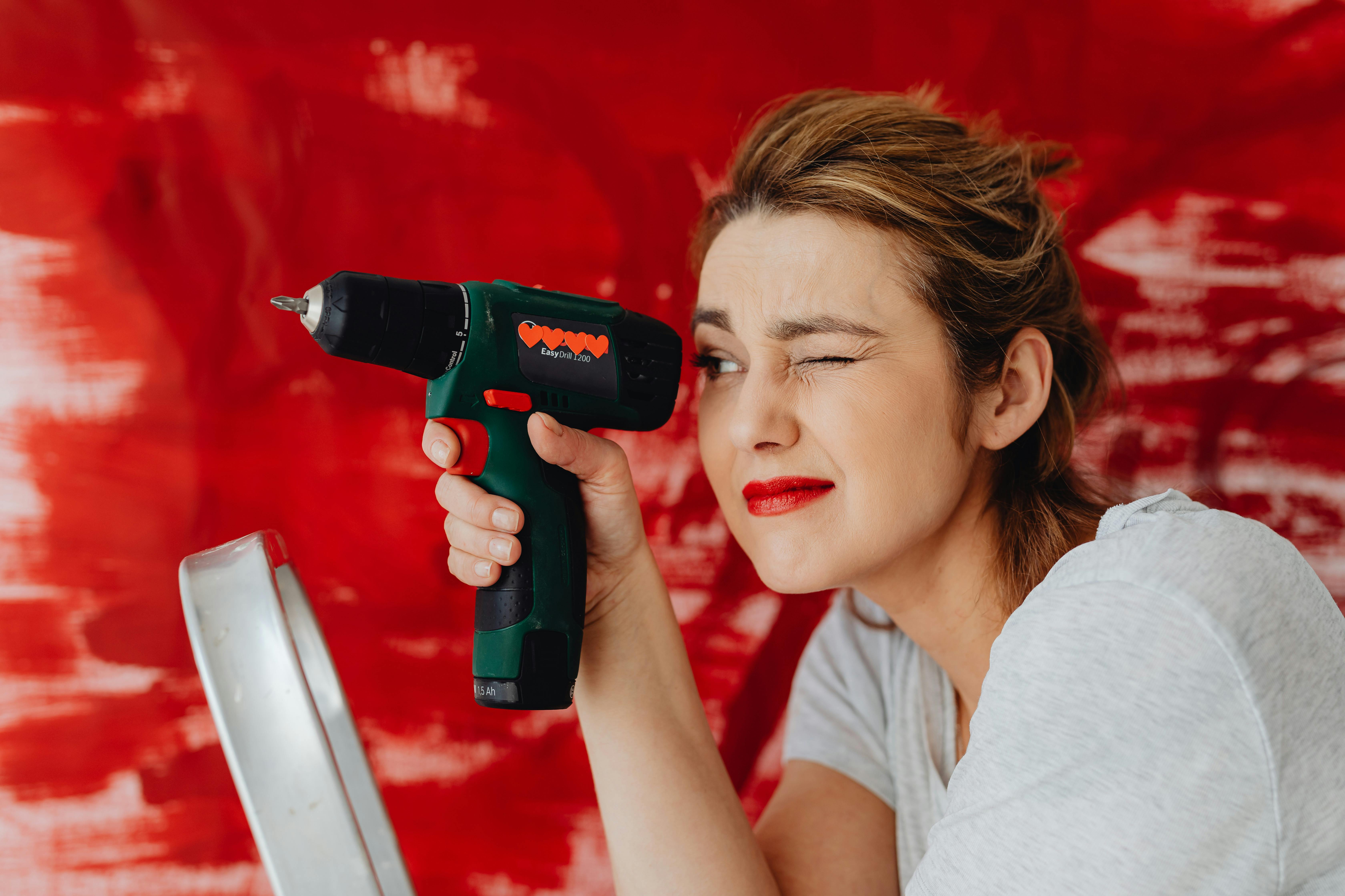 close up of woman holding a power tool