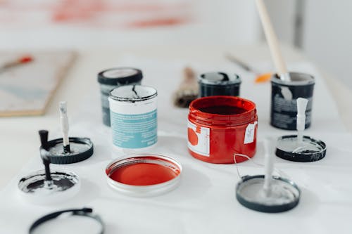 Shallow Focus of Paint Cans on White Surface