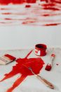 Red Paint on White Paper Beside Red Plastic Bucket
