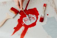 Person Holding Red Paint Brush