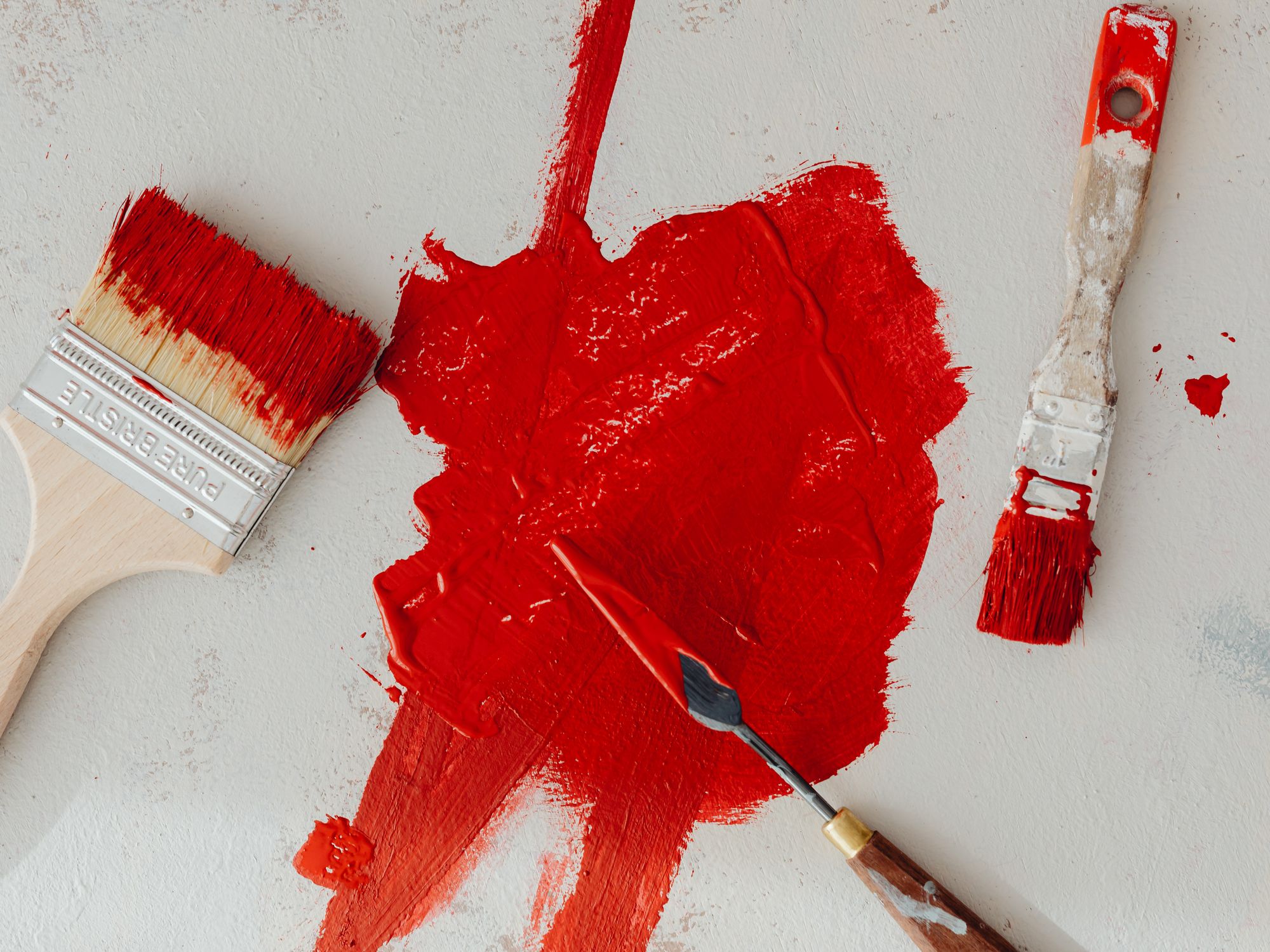 Painters & Decorators in Woodford Wells, London — professional decorator painting a wall with a roller