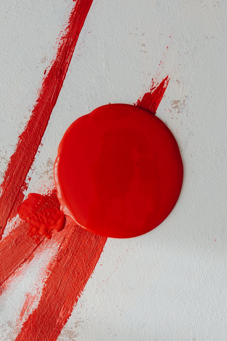 Red Paint Drop And Strokes On White Background