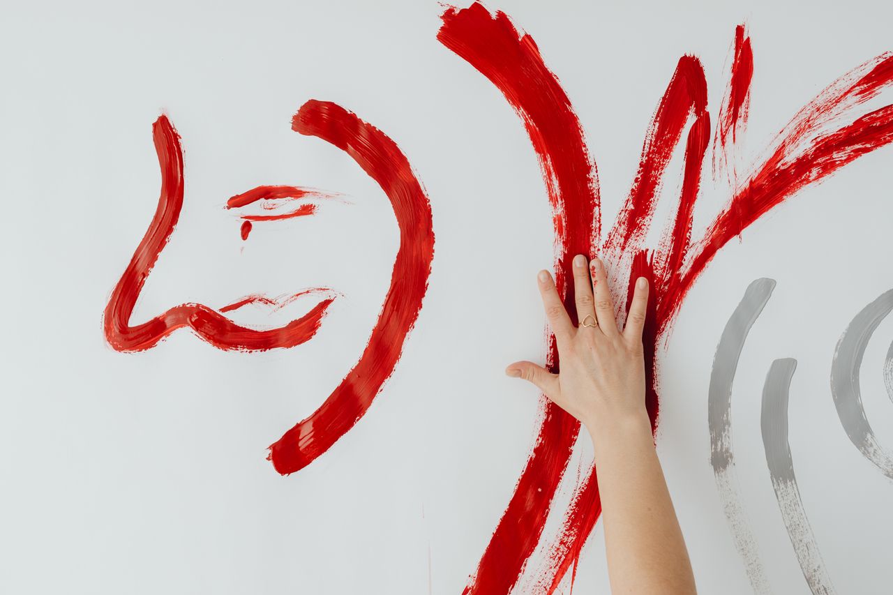 abstract red hand painting with expressive brushstrokes on canvas wall