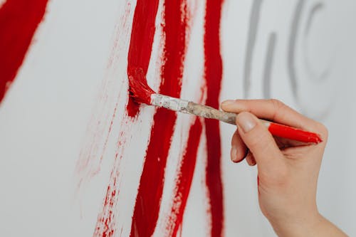 Close-up of Woman Painting with Red Paint 