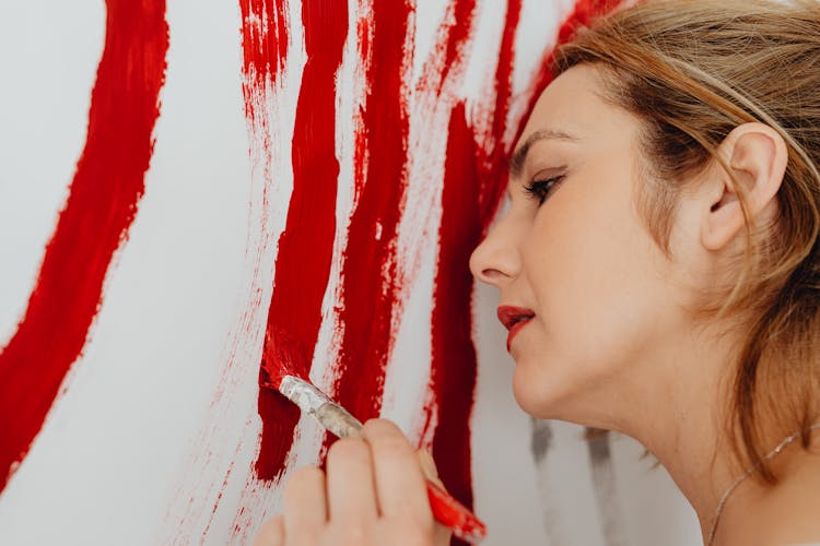 Close-up Of A Woman Focused On Painting 