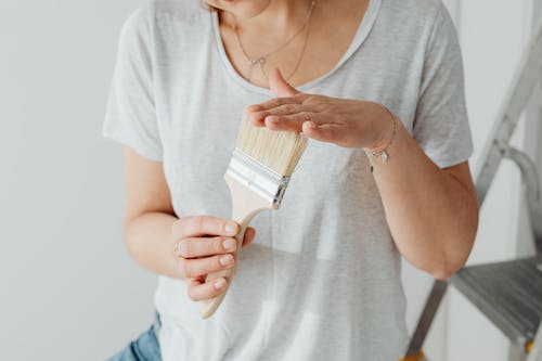 Free Photograph of a Woman's Hands Touching a Paintbrush Stock Photo
