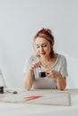 Woman in a Gray Shirt Stirring Her Coffee