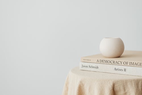 Free Books on a Table against a White Wall Stock Photo