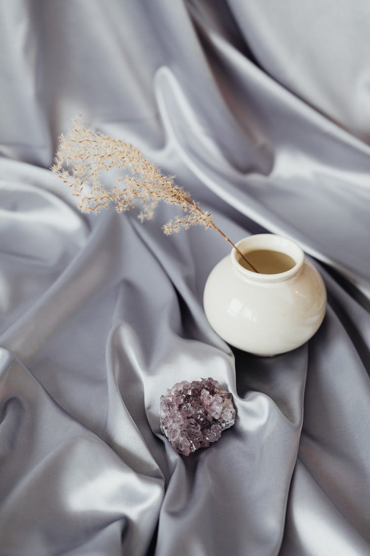 Dry Flower In A Cup And A Crystal Rock