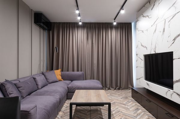 Furnished apartment living room with sectional sofa, photo by Max Vakhtbovych on Pexels