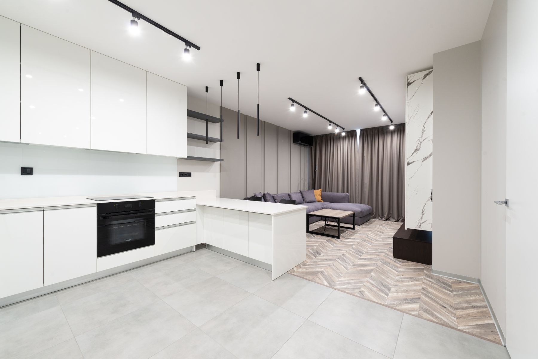 Bright modern open-plan home interior with neutral furnishings and a kitchen