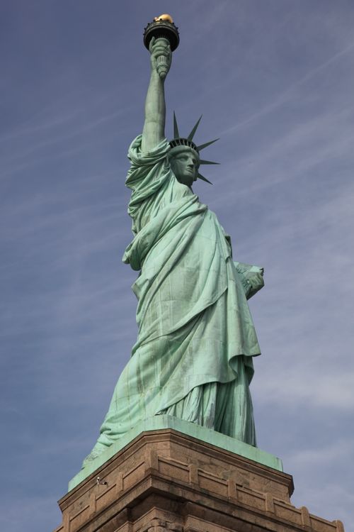 Free Iconic Statue of Liberty against a clear blue sky in New York City. Stock Photo