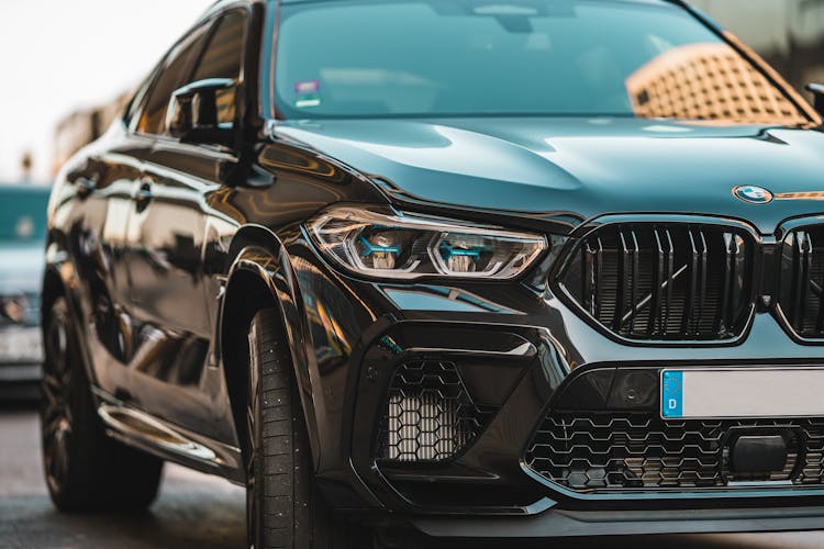 A Black Luxury Car On The Road