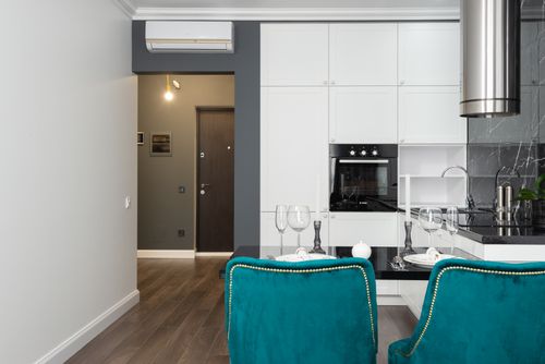 Free Sleek minimalist kitchen featuring white cabinets and teal accents with a touch of elegance. Stock Photo