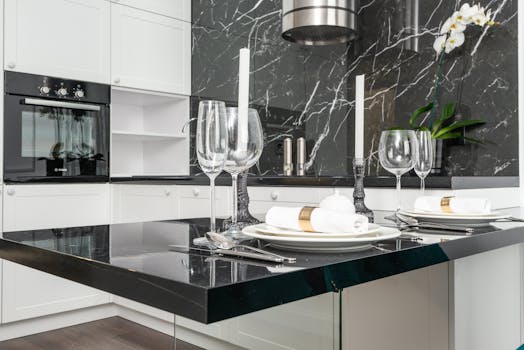 A stylish and spacious modern kitchen featuring a marble countertop, elegant decor, and dining setup.