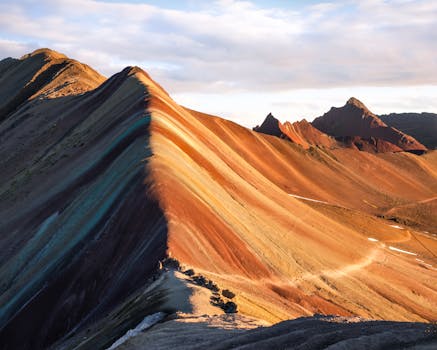 Rainbow Mountain in Peru features vibrant colors from natural mineral deposits.